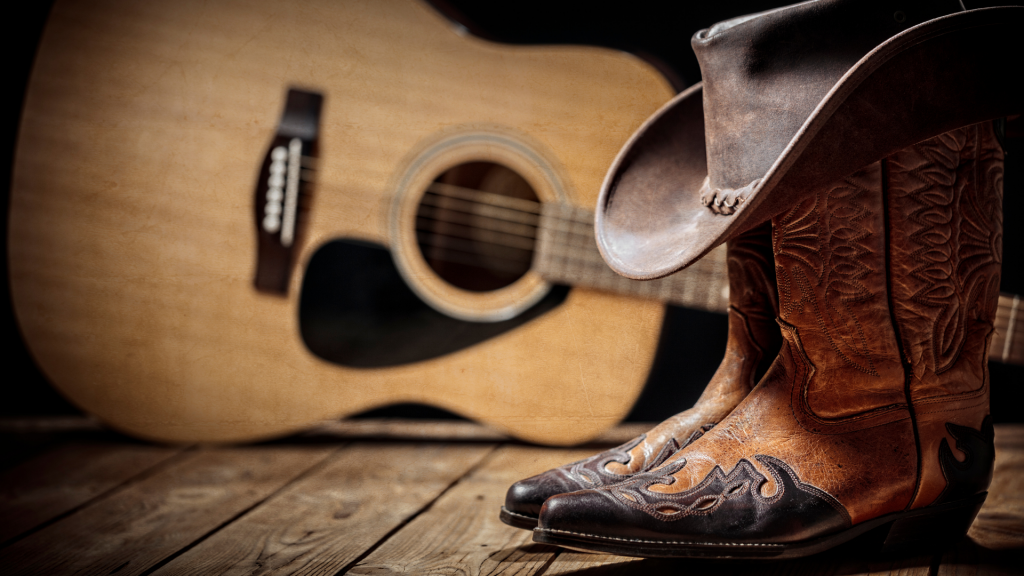 country music memorabilia including guitar cowboy boots and hat